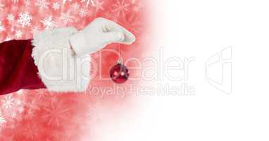 Santa holding bauble decoration and Snowflake Christmas pattern and blank space