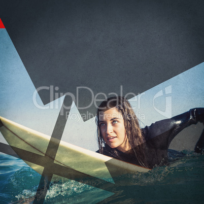woman in wetsuit with a surfboard on a sunny day