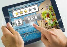 Hand touching tablet with Rate button and review stars with food