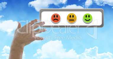 Hand touching smiley faces feedback buttons