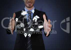 Mixed various app icons connected and Businessman with hands palm open and dark background