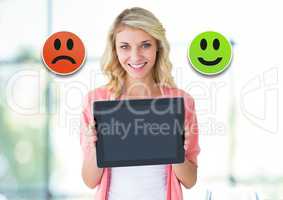 Woman holding tablet with feedback smiley face satisfaction icons