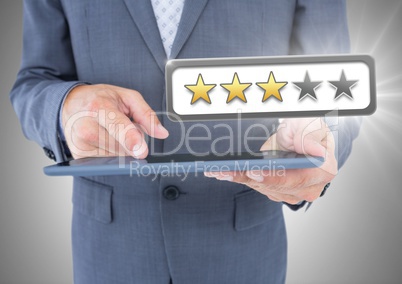 Hands holding tablet with review star ratings