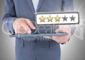 Hands holding tablet with review star ratings