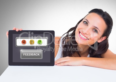 Woman holding tablet with feedback smiley satisfaction icons