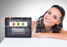 Woman holding tablet with feedback smiley satisfaction icons