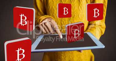 Hands holding tablet with bitcoin symbol icons