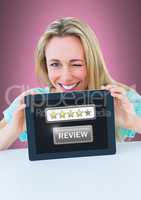 Woman holding tablet with star ratings review button