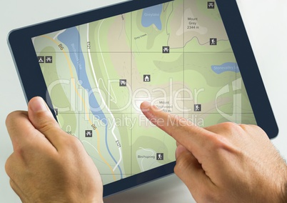 Hand touching tablet with map locations