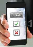 Hand holding phone with feedback buttons