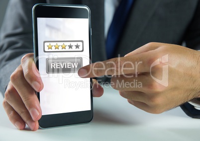 Hand touching review button and star ratings review on phone