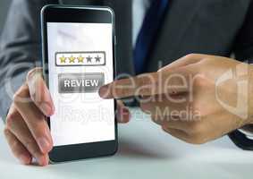 Hand touching review button and star ratings review on phone