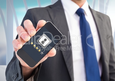 Rating review stars on phone in man's hand