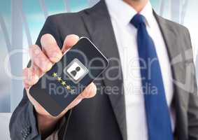Rating review stars on phone in man's hand