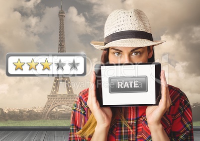 Woman holding tablet with rate button and star reviews over Paris