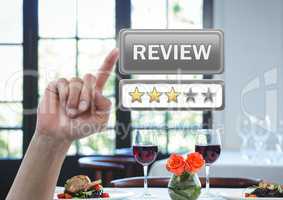 Hand touching review button and star ratings in restaurant
