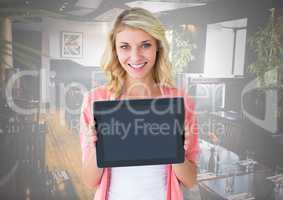 Woman holding tablet with restaurant background