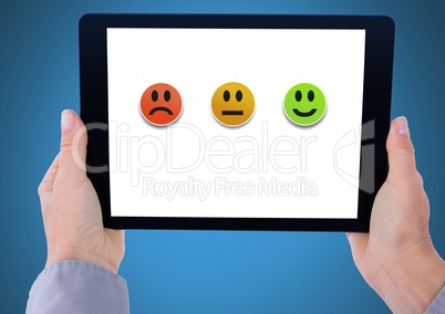 Hands holding tablet with feedback satisfactoin smiley faces