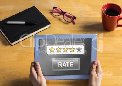 Hands holding tablet with  rate button and star ratings review