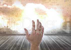 Hand reaching with cloud in room