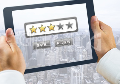 Hand holding tablet over city with star ratings and review button