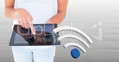 Hand touching tablet with 3D wi-fi icon