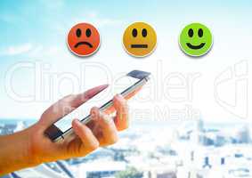 Hand holding phone and Feedback smiley satisfaction icons