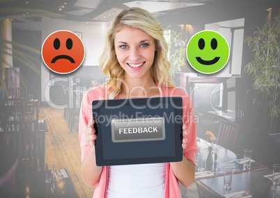 Woman holding tablet with feedback smiley face satisfaction icons