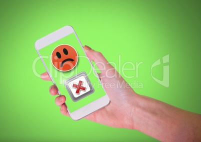 Hand holding phone with sad smiley face and X negative wrong button