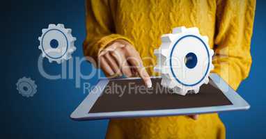 Hand holding tablet with 3D cogs icon