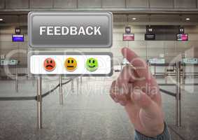 Hand pointing at feedback button and smiley faces review in airport
