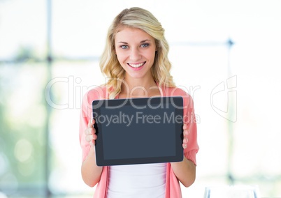 Woman holding tablet with bright natural window light