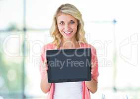 Woman holding tablet with bright natural window light