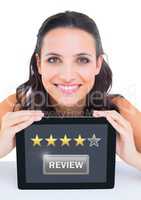 Woman holding tablet with review star ratings