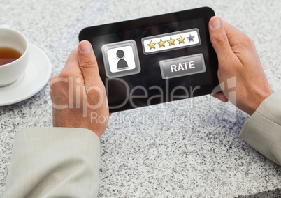 Hands holding tablet with rate button and star ratings review