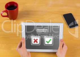 Hands holding tablet with feedback buttons