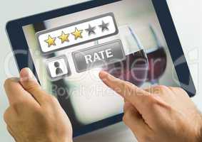 Hand touching tablet with Rate button and review stars in wine bar