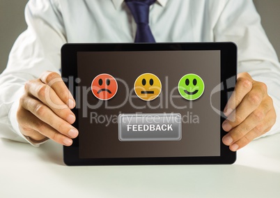 Hands holding tablet with smiley face feedback satisfaction icons