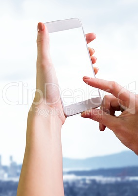 Hand holding phone with landscape white washed