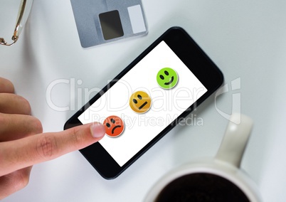 Hand touching phone ith smiley feedback satisfaction icons