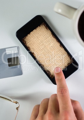 Hand touching phone with coffee sack background