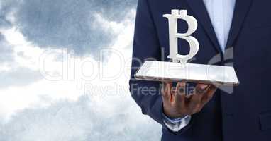 Hand holding tablet with bitcoin symbol icon