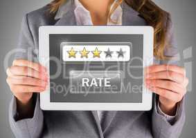 Hands holding tablet with review star ratings