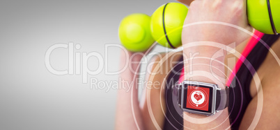 Composite image of happy woman lifting green dumbbells