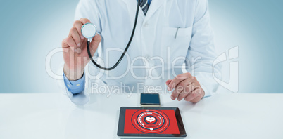 Composite image of doctor examining with stethscope