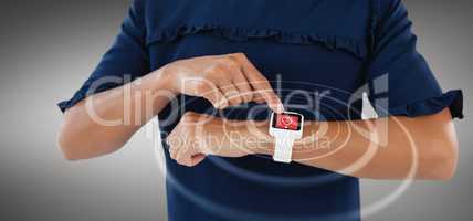 Composite image of mid section of female executive using smartwatch