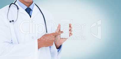 Midsection of male doctor pointing on mobile phone