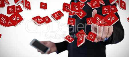 Composite image of mid section of businessman holding smartphone while using invisible interface