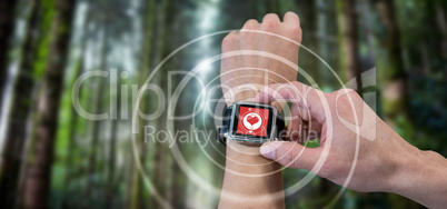 Composite image of cropped image of man using watch