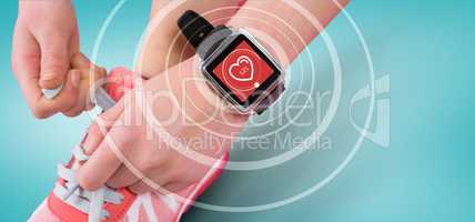 Composite image of fit woman using smartwatch